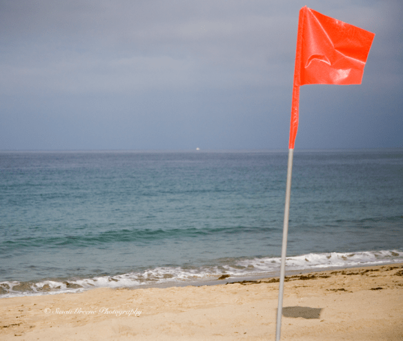 red orange flag on beach