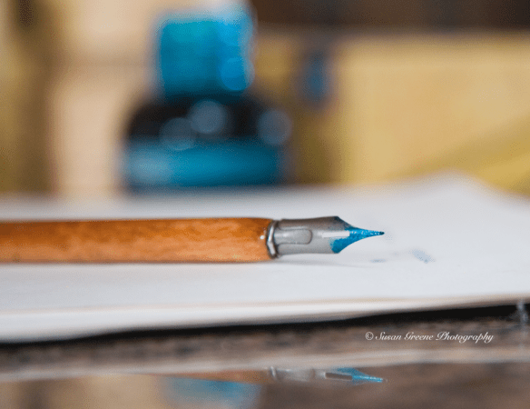 wooden dip pen with ink on tip