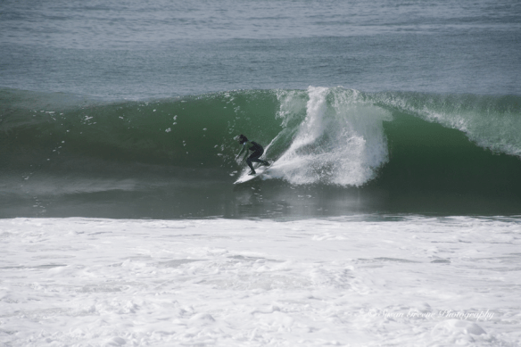 surfer riding big wave Redondo Beach, CA