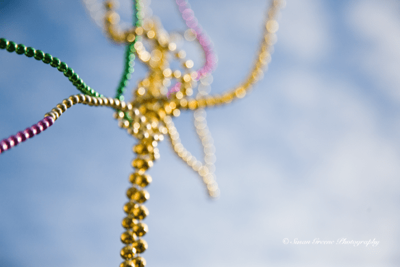 Mardi Gras beads in flight